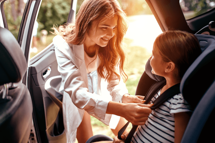 a mother safely locking her child on the baby seat